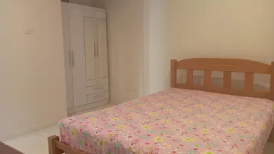 a bedroom with a bed and a closet with a door at Hermoso Departamento Con Vista Al Mar in Punta Hermosa