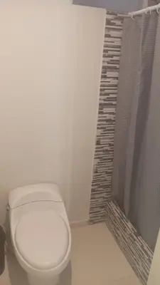 a bathroom with a white toilet and a shower at Hermoso Departamento Con Vista Al Mar in Punta Hermosa