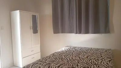 a bedroom with a zebra print bed and a dresser at Hermoso Departamento Con Vista Al Mar in Punta Hermosa