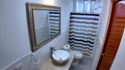 a bathroom with a toilet and a mirror at Paradice a 30 minutos del Boulevar de Asia