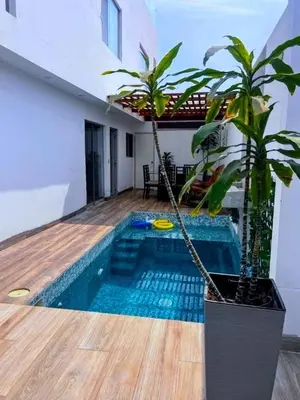 a house with a pool with a plant next to it at Paradice a 30 minutos del Boulevar de Asia