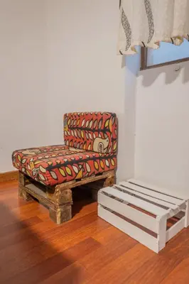 a chair sitting in a room next to a window at Room A Charming Matrimonial Room in Historic San Blas in Cusco