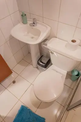 a bathroom with a white toilet and a sink at Room C Relaxing Stay With Extra Comfort in Cusco