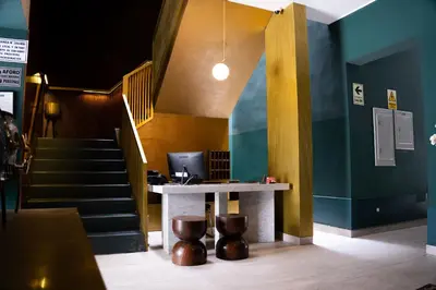 a lobby with a desk with a computer on it at Olivar House Hotel in Lima