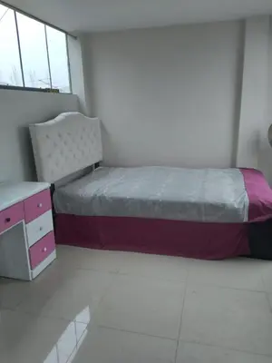 a bedroom with a bed and a dresser in it at Agua dulce in Lima