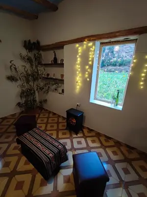 a living room with a couch and a window at Loft acogedor in Ollantaytambo