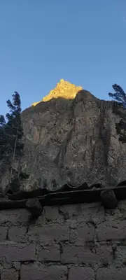 a mountain on top of a stone wall at Wonderful Full House in Ollantaytambo