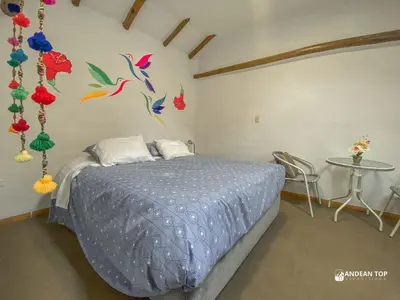 a bedroom with a bed with colorful birds on the wall at Room D Comfort Family Suite Near Historic Cusco in Cusco