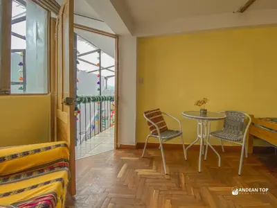 a room with a table and chairs and a balcony at Room F Charming Room for Couples or Friends in Cusco