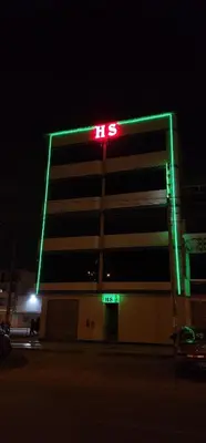a lit up building with a tes sign on it at Hospedaje AMAZONAS in Lima