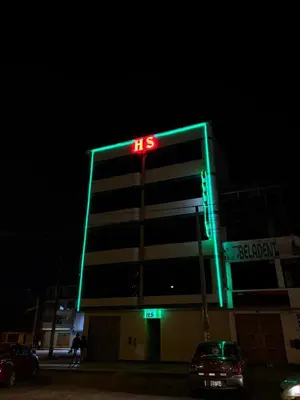a large building with a neon sign on it at Hospedaje AMAZONAS in Lima