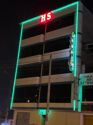 a building with ahs sign and a traffic light at Hospedaje AMAZONAS in Lima