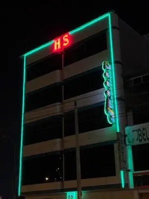 a building with a neon sign in front of it at Hospedaje AMAZONAS in Lima