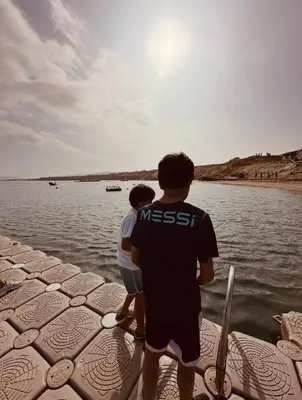 two men standing on a boat looking at the water at Paracas Navigare 2 BD Vista Reserva y Mar Último piso Terraza Kamado BBQ in Santo Domingo