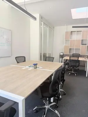 an office with a large wooden table and chairs at Paracas Navigare 2 BD Vista Reserva y Mar Último piso Terraza Kamado BBQ in Santo Domingo