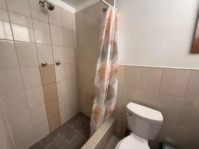 a shower curtain in a bathroom with a toilet at Hostal La Reserva - Pisco in Pisco