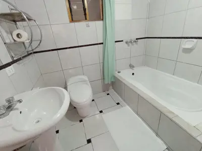 a bathroom with a sink and a toilet and a tub at Huilka Mayu in Urubamba