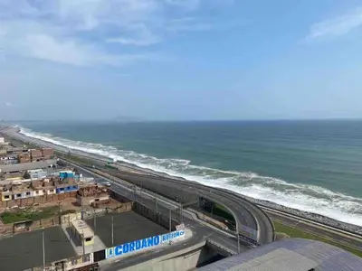 an overhead view of a highway next to the ocean at COSTANERA Uno in Lima