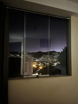 a view of a city from a window at night at All sur departamento in Machu Picchu
