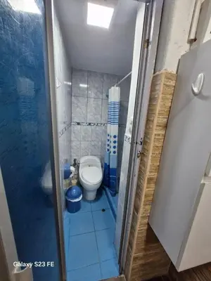 a small bathroom with a toilet and a shower at All sur departamento in Machu Picchu