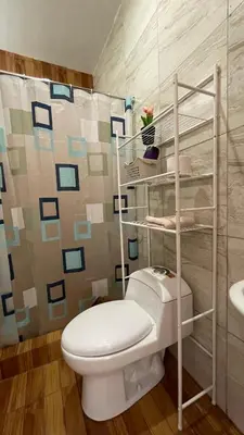 a bathroom with a white toilet and a sink at Casa Departamento en el Valle de Urubamba in Urubamba