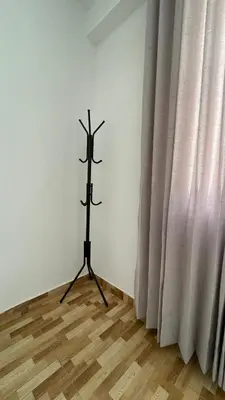 a black stand in a room next to a curtain at Departamento en Urubamba in Urubamba