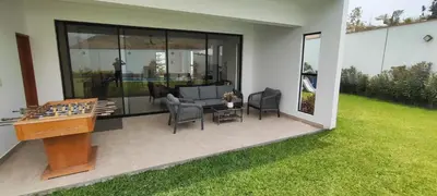 a patio with a ping pong table and chairs at Casa Ribera Este in Cieneguilla