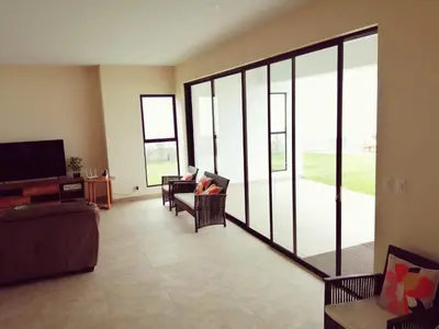 a living room with a couch and chairs and windows at Casa Ribera Este in Cieneguilla