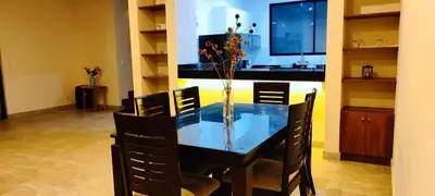 a dining room table with a vase of flowers on it at Casa Ribera Este in Cieneguilla