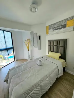 a bedroom with a large bed and a window at Apartamento Moderno in Lima