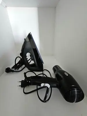a black hair dryer with a monitor on top of it at Apartamento Moderno in Lima