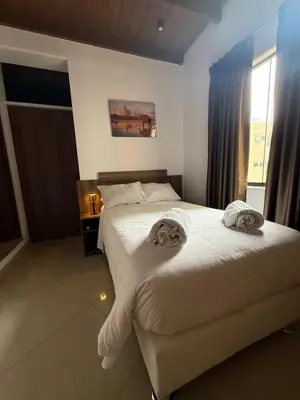 a bedroom with two beds with towels on them at Serendipia City Comfort Suite 901 in Lima