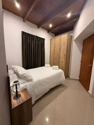 a bedroom with a large bed and a window at Serendipia City Comfort Suite 901 in Lima