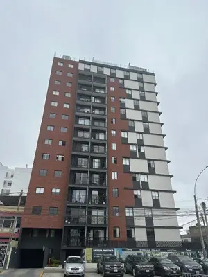 a tall building with cars parked in front of it at Luxury Duplex on the 15th Floor with Terrace in Lima