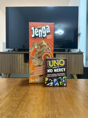 two boxes of uno and no mercy on a table at Luxury Duplex on the 15th Floor with Terrace in Lima