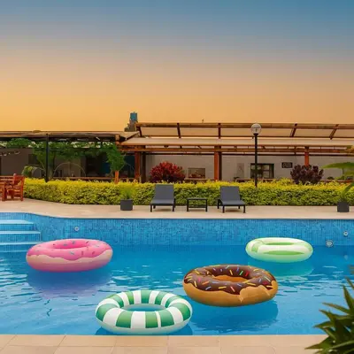 a swimming pool with three inflatables in the water at Huaral House Piscina y Terraza in Huaral