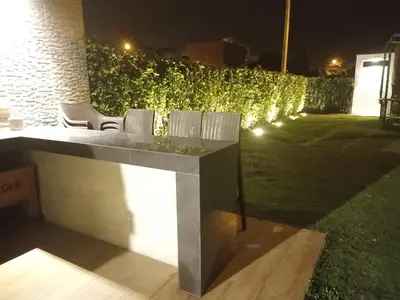 a table and chairs in a yard at night at Casasol in Santa Rosa