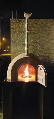 a pizza oven with a fire inside of it at Casasol in Santa Rosa