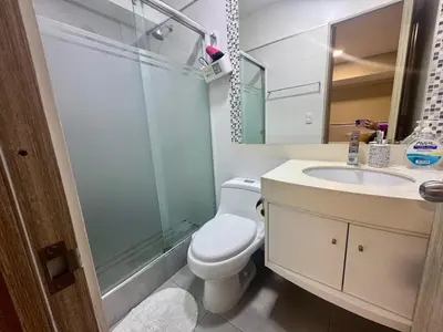 a bathroom with a toilet and a shower and a sink at Departamento completo vista al mar,piscina,gimnasio,WIFI,Tvs in Lima