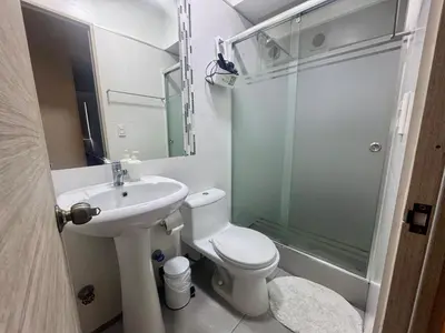 a bathroom with a toilet and a sink and a shower at Departamento completo vista al mar,piscina,gimnasio,WIFI,Tvs in Lima
