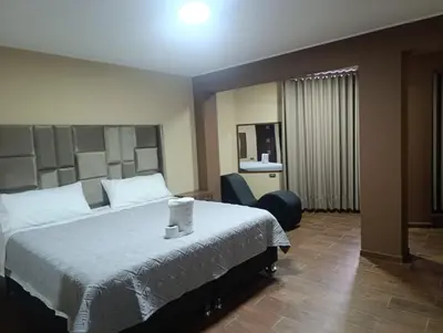 a hotel room with a bed and a chair at Kapricho Wanka in Huancayo