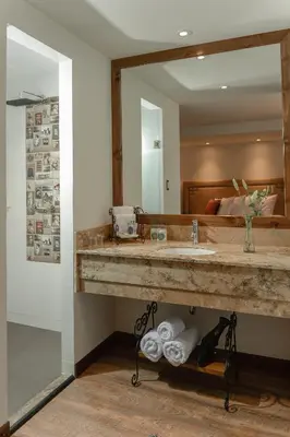 a bathroom with a sink and a large mirror at Casa Esmeralda by Katari in Cusco