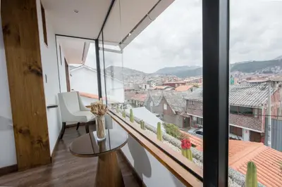 a room with a large window with a view of a city at Casa Esmeralda by Katari in Cusco