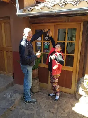 a man and a woman standing in front of a parking meter at EColodge Ccatan in Urubamba