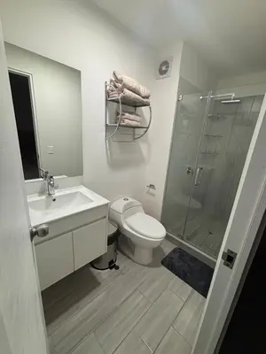 a bathroom with a toilet and a sink and a shower at Apartment in San Miguel De Estreno in Lima