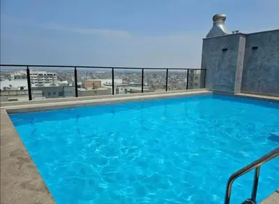 a swimming pool on the roof of a building at Apartment in San Miguel De Estreno in Lima