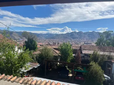 a view of a city with mountains in the background at Legendary Rock Cusco Apartment in Cusco