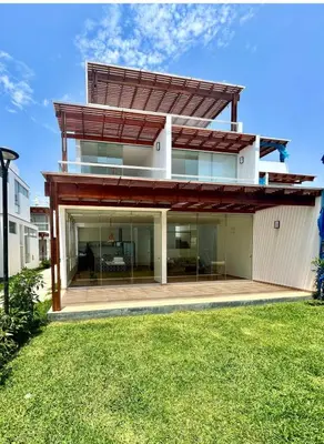 a modern house with a large glass facade at Beach House in Asia, Santorini Condominio in Asia