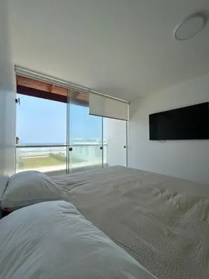 a bedroom with a large bed and a flat screen tv at Beach House in Asia, Santorini Condominio in Asia