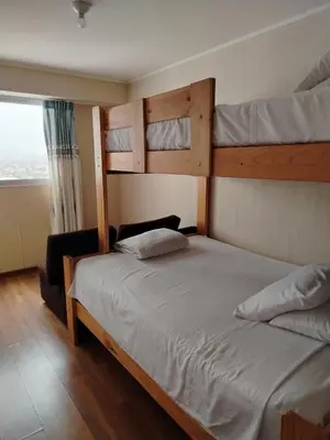 a bedroom with two bunk beds and a window at Departamento Executive 2BR Balcón Frente al Mall Santa Catalina in Lima